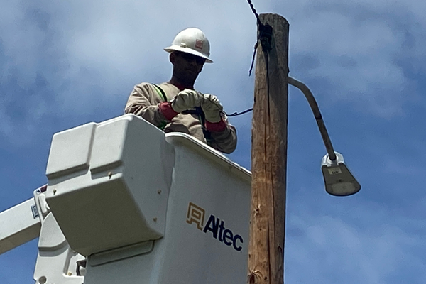 File photo of crew member working on a street light